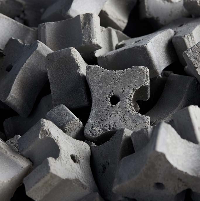 Fiber cement spacers for reinforced concrete